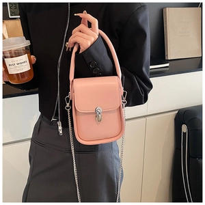 Detail of light pink mini leather bag with silver oval turn-lock and metal chain strap