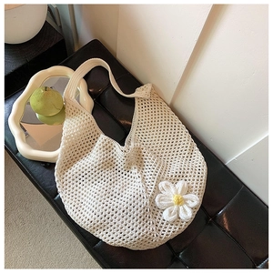 Detail of bohemian ivory crochet shoulder bag featuring a 3D daisy flower and woven texture