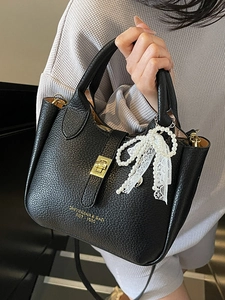 Classic black litchi leather bucket bag for women with golden lock and pearl bow charm