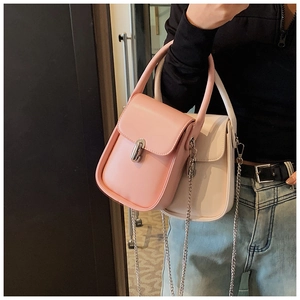 Pink and off-white mini crossbody bags with silver buckles and chain straps