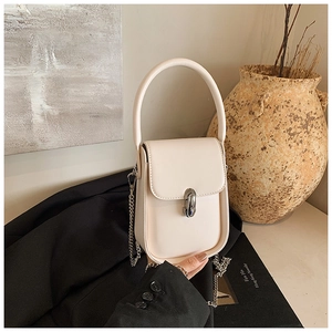 Close-up of a cream leather mini bag with silver oval lock and elegant metal chain strap
