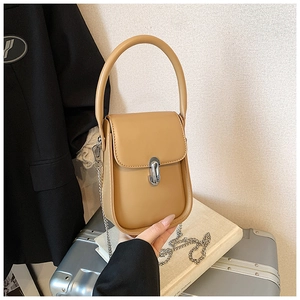 Detailed view of apricot PU leather mini bag with silver oval metal buckle and chain strap