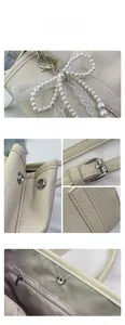 Détail du sac à main en cuir grainé avec pendentif perle et fermeture magnétique argentée
