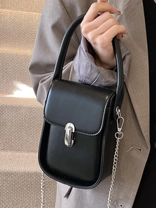 Chic black leather handbag with silver twist lock and chain strap for casual commuting