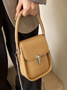 Minimalist light brown crossbody bag with silver chain strap and metal turn-lock buckle
