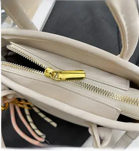 Detail of premium smooth gold zipper closure on the cream white bucket bag for women