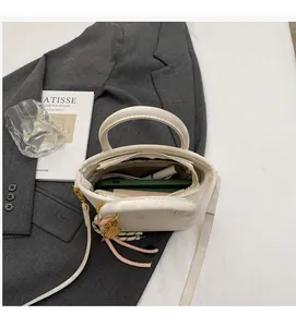 Top view of white synthetic leather bucket bag showing interior pocket and daily essentials