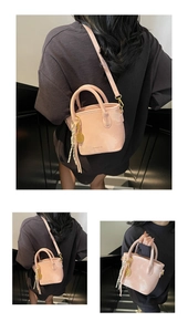 Detail of pink bucket bag with tennis racket charm and adjustable shoulder strap