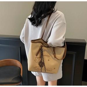 Detail of cute cat embroidery on a large cream and brown contrast shoulder tote bag