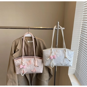 Detail of lace embroidery butterfly tote bag with pearl pendant and checkered ribbon