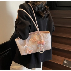 Detail of light pink floral lace shoulder bag with 3D butterfly embroidery and pearls