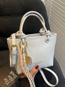 Classic light blue leather bucket bag with top handle and crossbody strap for women