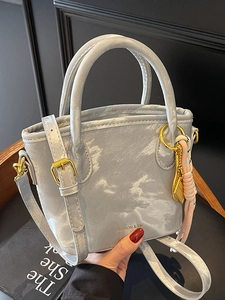 Elegant marble pattern bucket bag with golden hardware and adjustable crossbody strap