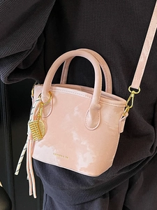 Pink marbled textured bucket bag with golden tennis racket charm and silk scarf detail