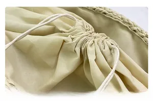 Detail view of the drawstring closure and high-density cotton lining of the woven tote bag