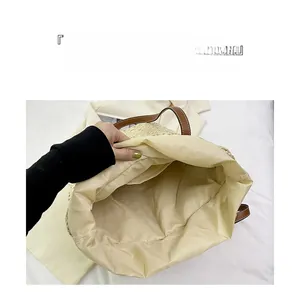 Detailed interior view of a large woven straw tote bag with inner pocket and lining