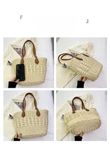 Detail view of woven straw tote bag with brown leather handles and large interior capacity