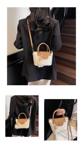 Détail du sac seau tressé avec texture crème, finitions cuir et charm en peluche