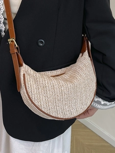 Minimalist straw crescent crossbody bag with brown leather trim and V-weave pattern