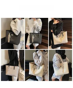 Detail showing various colors of large capacity tote bag with tassel charm and slim straps