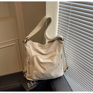 Detail of light beige casual tote bag showing nylon texture and BIFW embroidery text