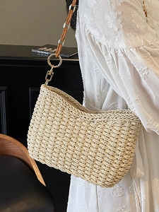 Beige woven straw shoulder bag with amber resin chain strap for bohemian summer vacations