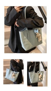 Close-up of light blue leather tote bag texture and cute plush dog pendant charm