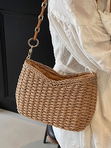 Handwoven straw shoulder bag with amber acrylic chain link strap and half-moon design