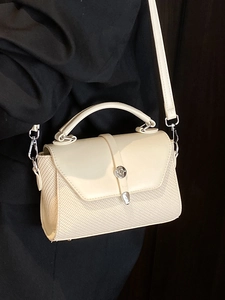 Minimalist beige woven crossbody bag with silver hardware and top handle for women