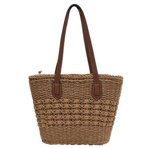 Minimalist hand-woven straw tote bag with hollow diamond pattern and brown leather straps