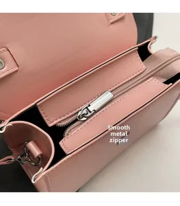 Detail of pink PU leather handbag featuring high-quality metal zipper and smooth hardware