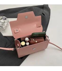 Pink crossbody bag interior showing storage for phone, wallet and lipstick