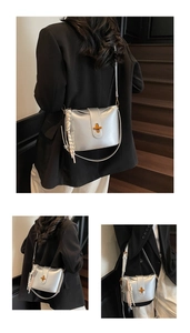 Detailed side view of silver oil wax leather crossbody bag with golden cross lock and tassel