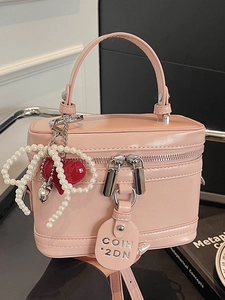 Pink leather vanity box bag with pearl bow and heart charms for elegant women