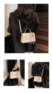 Detail view of a cream crossbody bag with a decorative silk scarf and adjustable strap