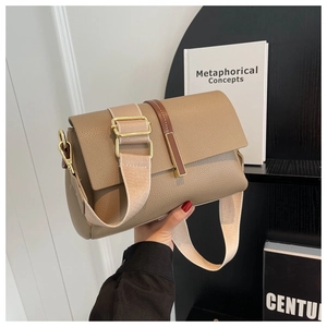 Detail of khaki pebbled leather shoulder bag with wide strap and gold metal buckle