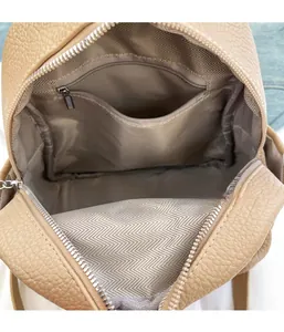 Detail of lychee pattern leather backpack showing inner zipper pocket and chevron lining