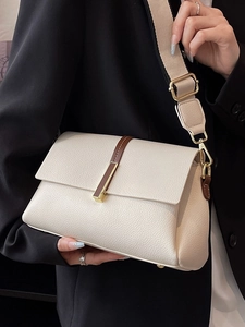 Chic beige lychee leather crossbody bag with brown accent strap and gold metal buckle