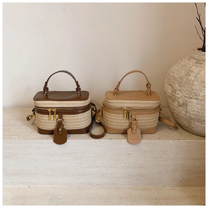 Detailed macro view of woven straw and premium leather texture on top handle vanity bags