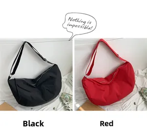 Detail of minimalist nylon tote bags in black and red colors with adjustable shoulder straps
