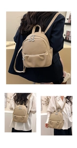 Detail of light khaki lychee pattern leather mini backpack with metal double zippers