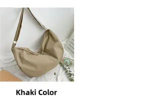 Detail of khaki crescent crossbody bag made of water-resistant nylon on a white background