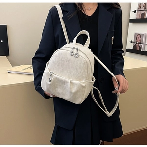 Beige lychee texture mini backpack shown on model to demonstrate size and daily style