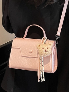 Minimalist light pink crossbody square bag with top handle and plush bear charm