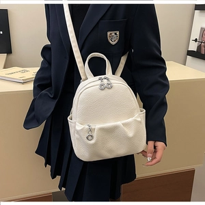 Detailed macro view of white lychee pattern PU leather on a stylish mini backpack
