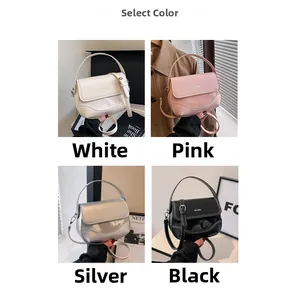 Detail view of stylish saddle bags in white, pink, silver, and black with brand logo