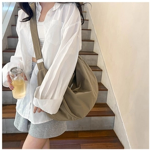 Side view of large khaki crossbody hobo bag showing spacious capacity and nylon texture