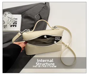 Detailed interior of minimalist box bag showing main compartment and zipper pocket