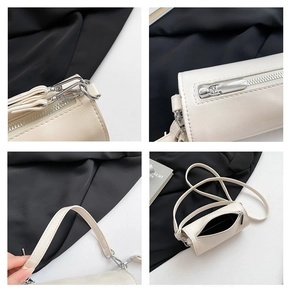 Detailansicht der cremefarbenen Zylindertasche mit silbernen Beschlägen und Leder