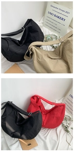 Detail of three nylon hobo bags in black, khaki, and red with adjustable wide straps